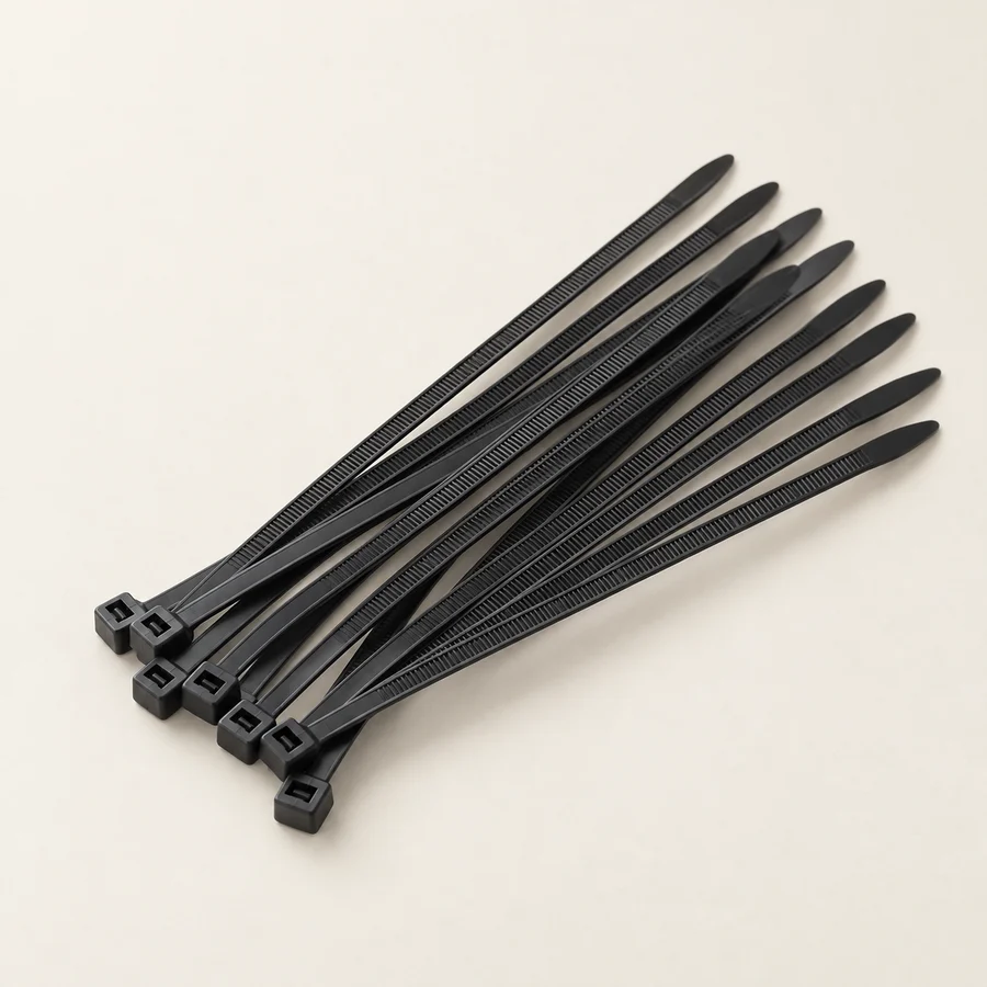 Unbranded black nylon cable ties on neutral background; show actual tie heads and proportions.